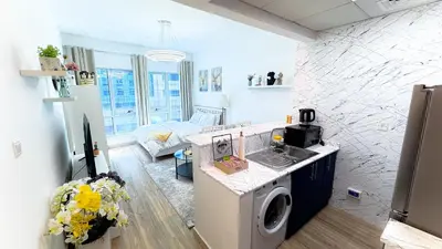 a kitchen and living room with a washing machine at Dubai Marina - Modern Designed - Gorgeous Studio- Close Metro Station in Dubai