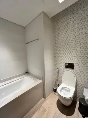 a bathroom with a toilet and a bath tub at Palace Dubai Creek Harbour Residences Skyline Apartment in Dubai