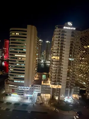 a view of a large building at night at Cozy Spacious AG Tower Business Bay, Dubai in Dubai