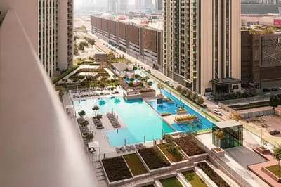 an aerial view of a swimming pool in a city at Burj Khalifa View, 2 Balcony w Lounge, Dubai Mall Access, Gym, Infinity-Pool, Playground, BBQ, Family Friendly in Dubai