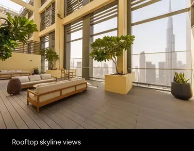 a room with couches and potted plants in a building at Mesmerizing view of Burj Khalifa in Dubai