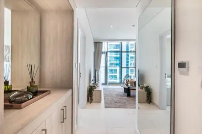 a bathroom with a sink and a glass door to a hallway at The Smart Concierge - Seven Palm in Dubai