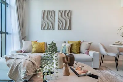 a living room with a couch and a christmas tree at The Smart Concierge - Seven Palm in Dubai