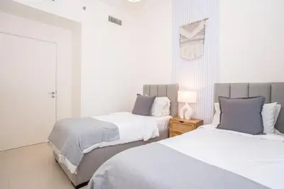 two beds sitting next to each other in a bedroom at 3 Bedroom Family Apartment from High Floor Downtown Views 183BC-3 in Dubai