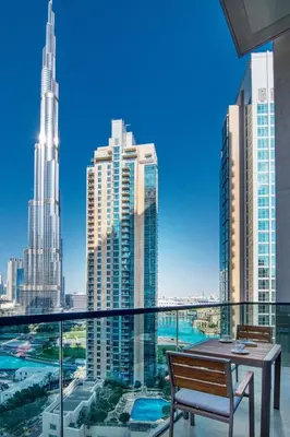 a balcony with a table and a view of a city at Amazing 2BR Burj Kalifa View in Dubai