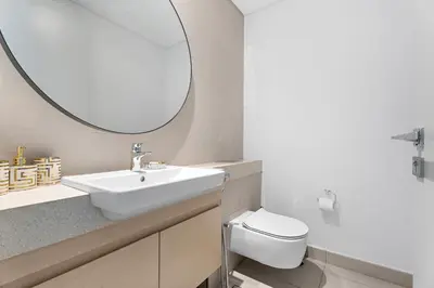 a bathroom with a white sink and a mirror at Luxurious 6-Sleeper Villa with Large Outdoor Patio in Dubai