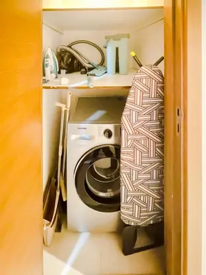 a small kitchen with a washing machine in a cabinet at Spacious 1-Bed Apartment Next to Dubai Mall 157CL2-1 in Dubai