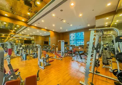 a gym with a lot of treadmills and machines at Spacious 1-Bed Apartment Next to Dubai Mall 157CL2-1 in Dubai