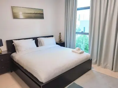 a bed in a bedroom with a large window at Spacious 1-Bed Apartment Next to Dubai Mall 157CL2-1 in Dubai