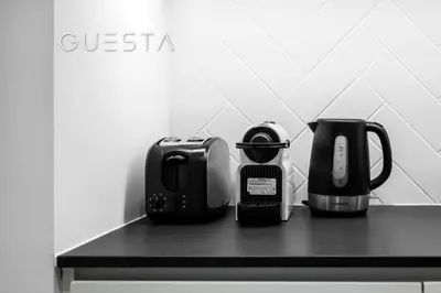 a counter top with a coffee maker and a coffeemaker at Belgravia Square, Jumeirah Village Circle in Dubai