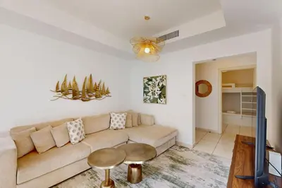 a living room with a couch and a table at The Springs - Tranquil Two Bedroom Villa in Dubai