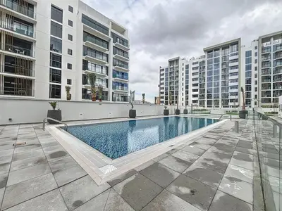 a large swimming pool in the middle of a building at Azizi Riviera 16 - Charming Studio in Dubai