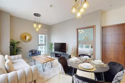 a living room with a table and a couch at Standpoint Tower A - Perfect One Bedroom in Dubai
