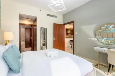 a bedroom with a white bed and a mirror at Standpoint Tower A - Perfect One Bedroom in Dubai