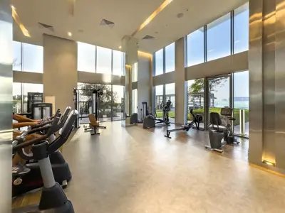 a gym with tread machines and large windows at 5242 Tower 2 - Chic Two Bedroom in Dubai