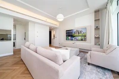a living room with a couch and two chairs at Upgraded Banyan Tree 2 Bed in JLT in Dubai