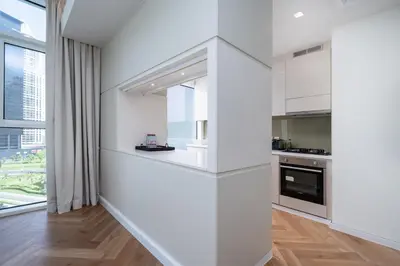 a kitchen with white walls and a large window at Upgraded Banyan Tree 2 Bed in JLT in Dubai