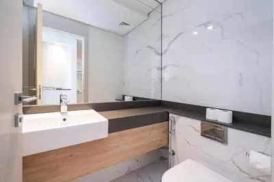 a bathroom with a white sink and a mirror at Upgraded Banyan Tree 2 Bed in JLT in Dubai