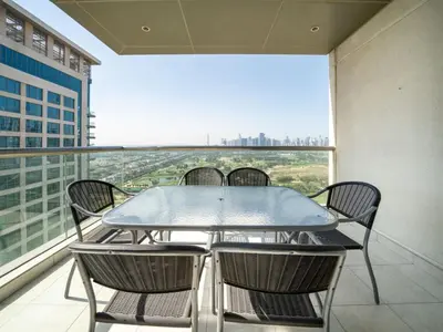 a table and chairs on a balcony with a view at 2 Bedroom Delight in The Greens Dubai in Dubai