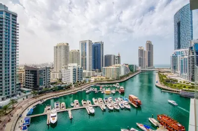 a city with boats docked in a harbor at The Smart Concierge - Stella Maris in Dubai