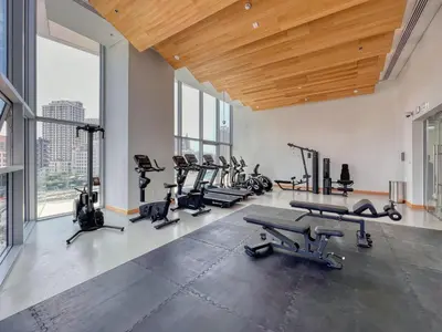 a gym with treadmills and exercise equipment in a building at The Smart Concierge - Stella Maris in Dubai