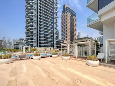 a rooftop patio with potted plants on a building at The Smart Concierge - Stella Maris in Dubai