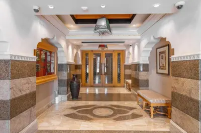 a hallway in a house with a lobby with a bench at GuestReady - Groove Getaway in Downtown Dubai in Dubai