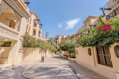 a street in the city with buildings and flowers at GuestReady - Groove Getaway in Downtown Dubai in Dubai