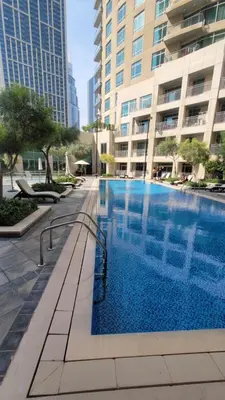 a large swimming pool in the middle of a building at Best Downtown Apartment in Dubai in Dubai