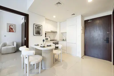 a kitchen with a table and chairs in a room at Modern Two Bedroom Apartment with Private Balcony By HSHOME - Downtown Dubai in Dubai