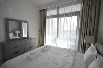 a bedroom with a bed with a mirror and a window at Experience Bliss 1BR Haven with Stunning Sea Views - 50AB1 in Dubai