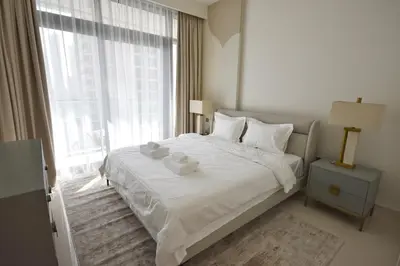 a white bedroom with a bed with towels on it at Experience Bliss 1BR Haven with Stunning Sea Views - 50AB1 in Dubai