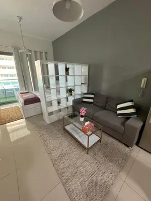 a living room with a couch and a coffee table at Studio Apartment near JBR in Dubai