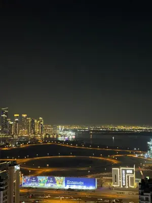 a view of a city at night with lights at Luxury 1bedrom Binghatti Avenue in Dubai