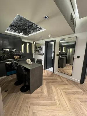 a kitchen and dining room with a table and chairs at Luxury 1bedrom Binghatti Avenue in Dubai
