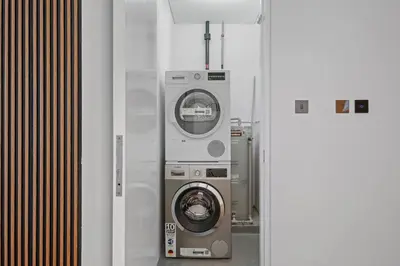 a washing machine and a washer in a room at Burj Khalifa & Downtown Views - 3BR Family Retreat Near Dubai Mall in Dubai