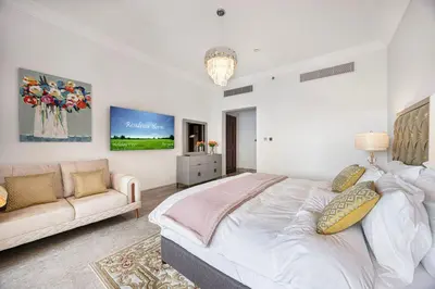 a bedroom with a large bed and a couch at Fairmont North 2BR 2 Balconies Sea View in Dubai