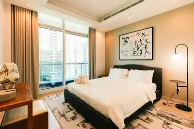 a bedroom with a bed and a large window at Stunning 2BR with Captivating Marina View - 17AB06 in Dubai