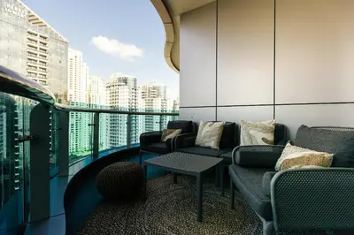 a balcony with couches and a view of a city at Stunning 2BR with Captivating Marina View - 17AB06 in Dubai