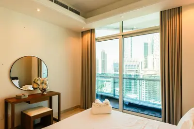 a bedroom with a large window and a mirror at Stunning 2BR with Captivating Marina View - 17AB06 in Dubai