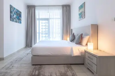 a bedroom with a large bed and a large window at 1BD apartment in Torch Tower, Dubai Marina in Dubai