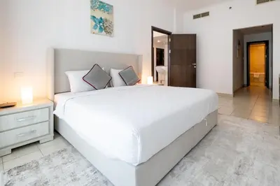 a large white bedroom with a large white bed at 1BD apartment in Torch Tower, Dubai Marina in Dubai
