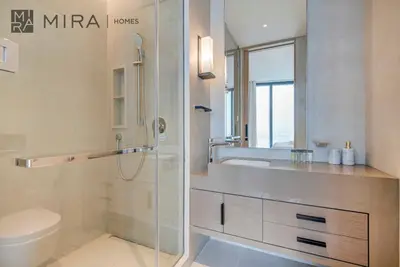 a bathroom with a shower and a sink and a toilet at Mira Holiday Homes - Lovely 2 BDR with Sea View in Dubai