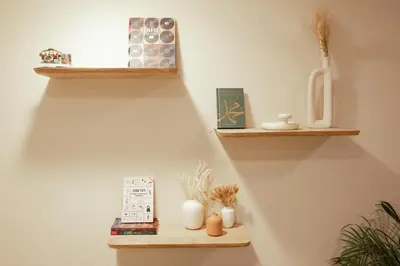 a wall with two wooden shelves on a wall at Arabian-Inspired 1BR - Polo Residence Near Burj in Dubai