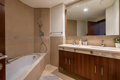 a bathroom with a tub and a sink and a mirror at 2BDR apartment near Burj Khalifa I Downtown Dubai I Burj Vista in Dubai