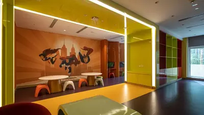 a room with two tables and a mural on the wall at Livin' Holidays - Luxury studio with Bay view in Dubai