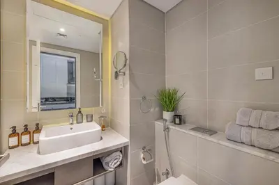a bathroom with a sink and a mirror at Livin' Holidays - Luxury studio with Bay view in Dubai