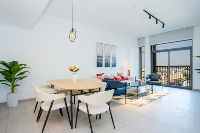 a living room with a table and a couch at Vacay Lettings 2 Bed Retreat near Burj Al Arab in Dubai