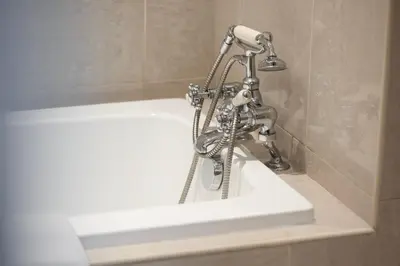 a faucet is sitting on top of a sink at Old Town Luxury: 1-BR Apartment with Large Terrace & Burj Khalifa View in Dubai