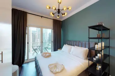 a bedroom with a large bed and a window at Shiny & Fresh - Studio with Lake View - JLT in Dubai